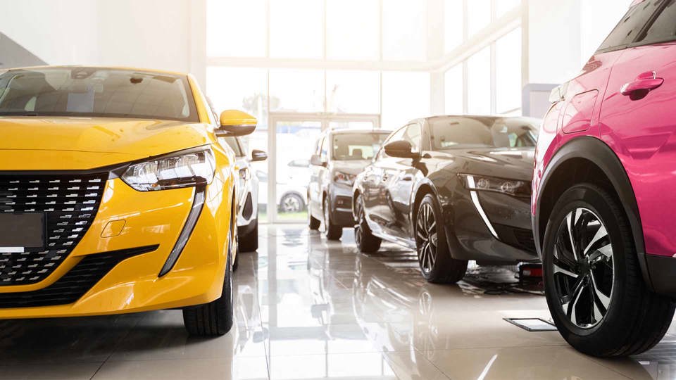 Peugeot Showroom with orange, pink and black cars
