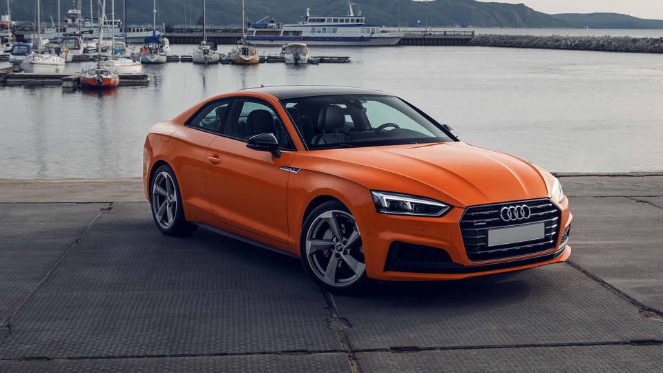 Orange Audi A5 parked at the docks