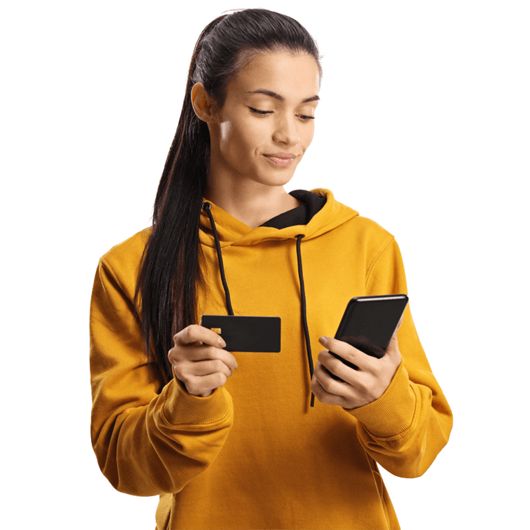 woman in a yellow hoodie holding a phone and smiling
