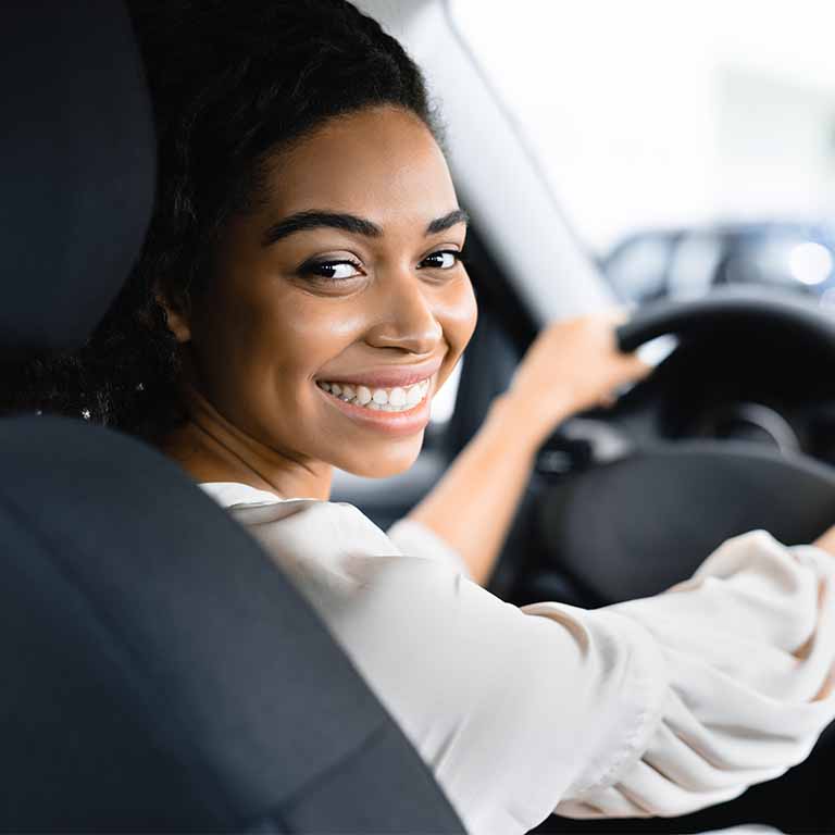 Happy Woman Driving Car