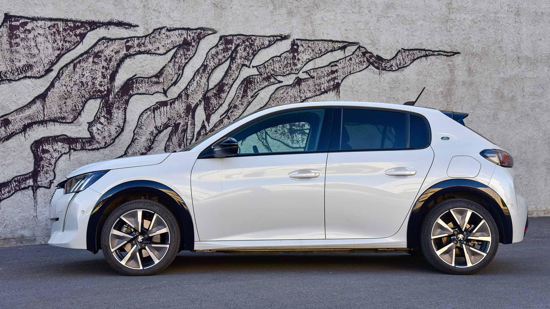 Side of a white electric Peugeot 208