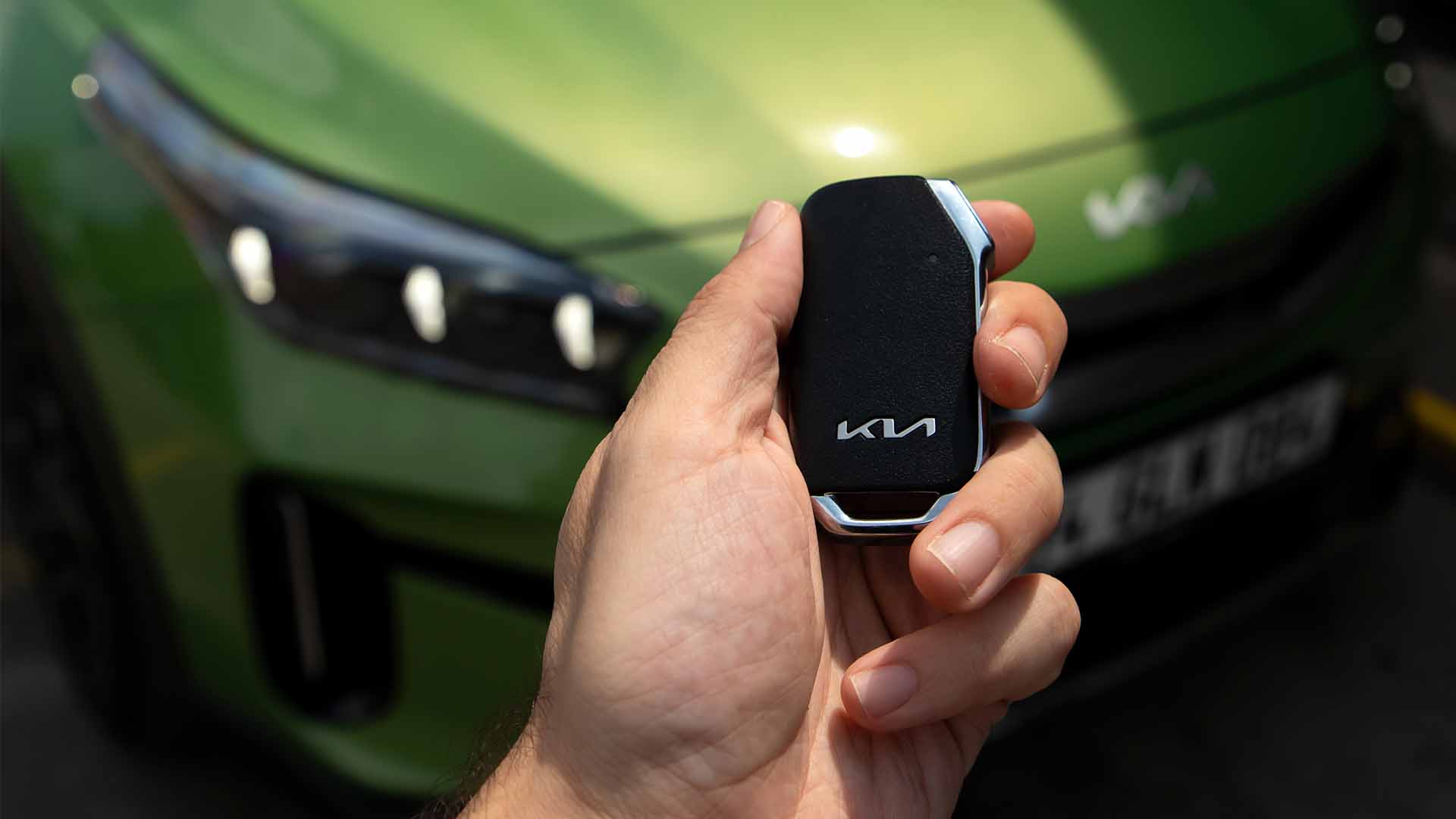Kia key above a green Kia