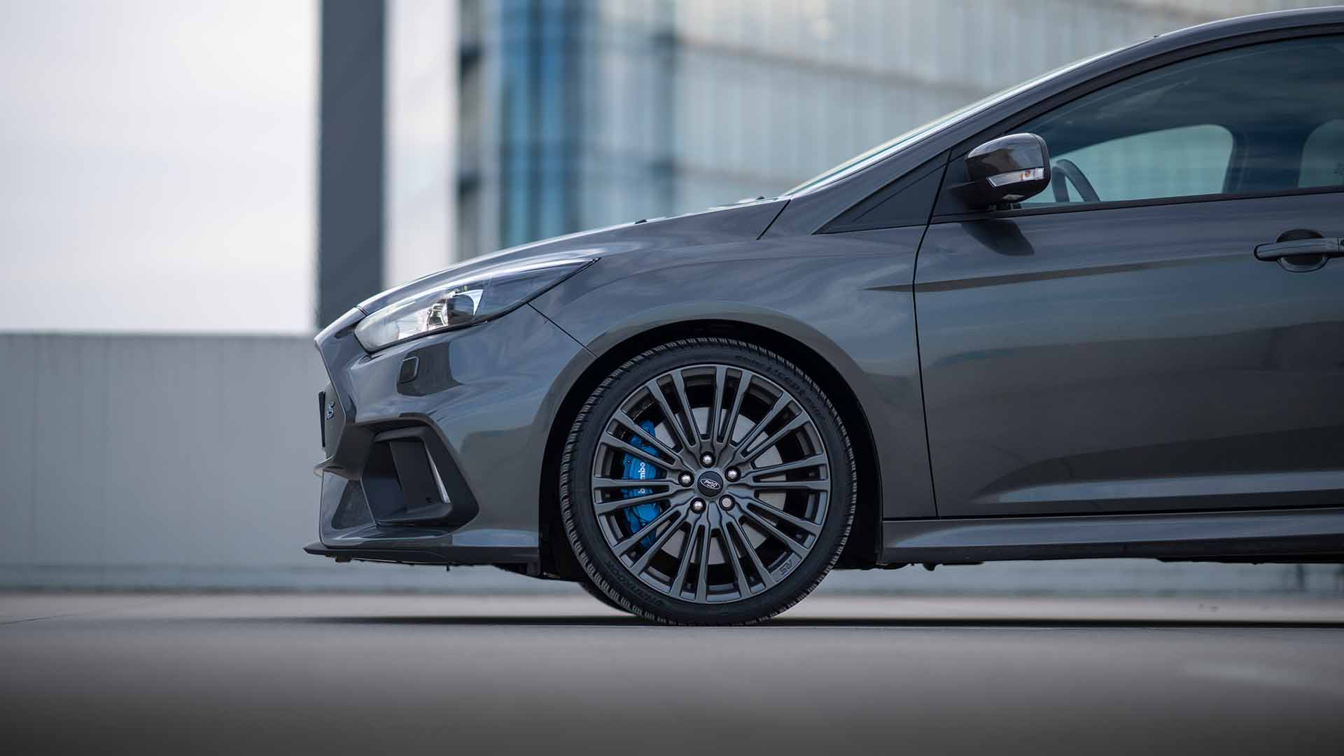Side view of the front of a grey car