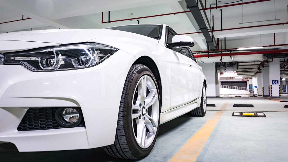 WHite car parked in an underground parking garage