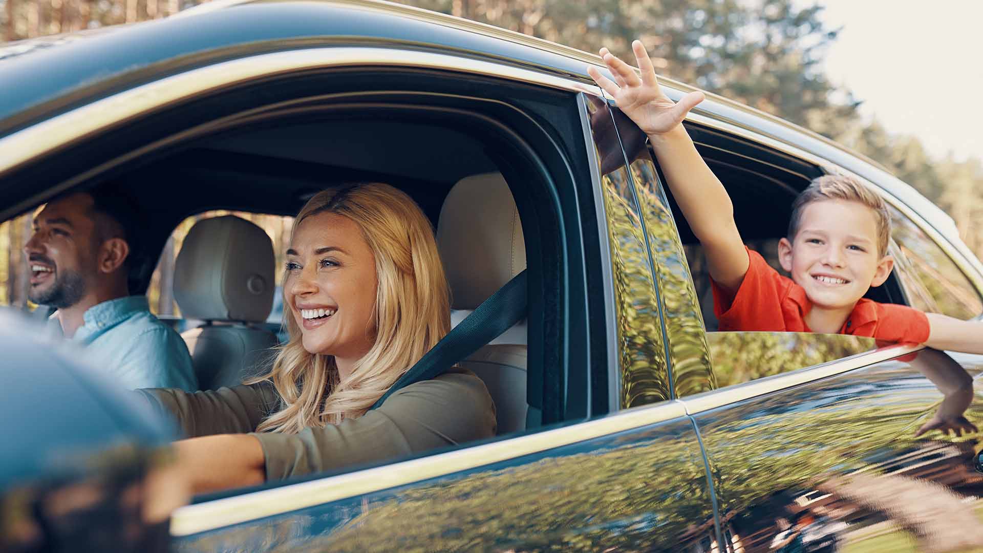 Family driving with a child in window