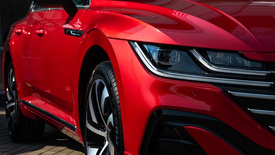 Front and side of a red Volkswagen Arteon