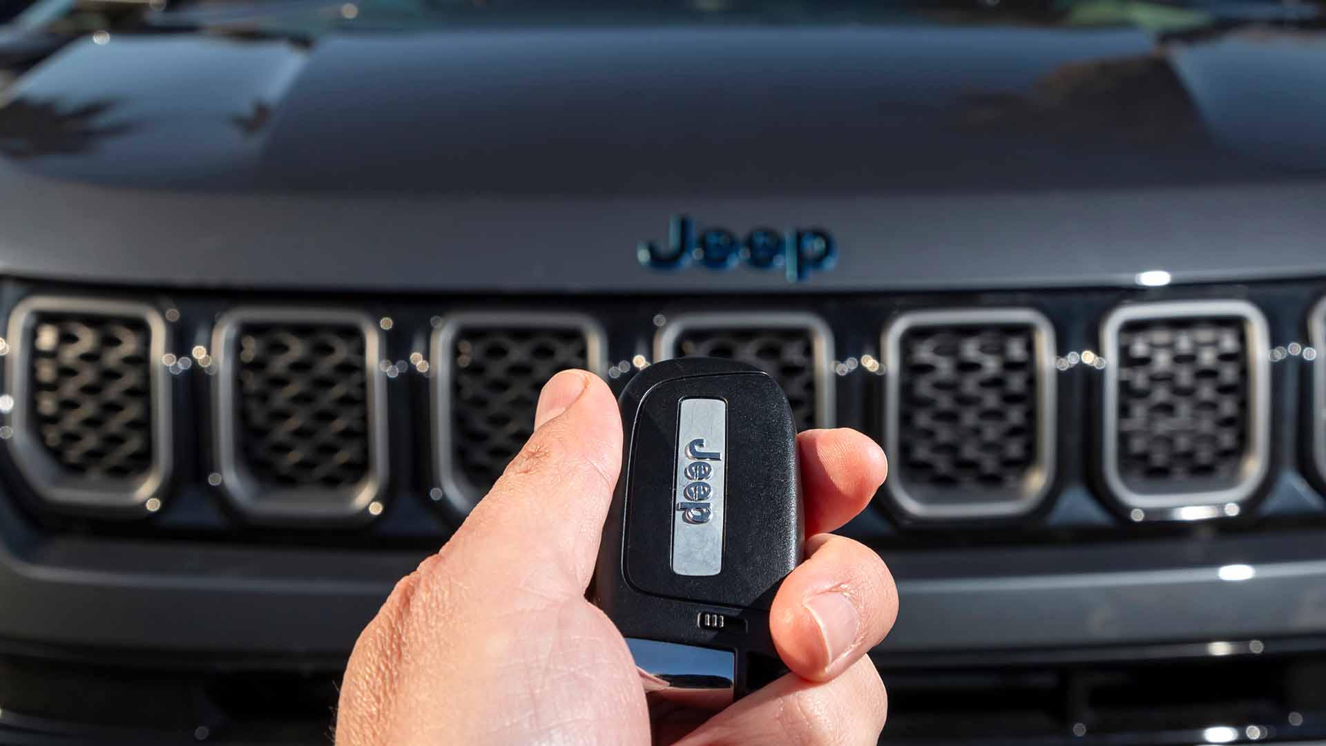 Holding Jeep Keys Infront Of Bonnet
